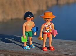 miniature figurines on the beach on a blurred background