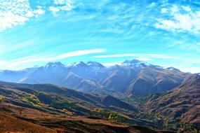 Beautiful landscape of the colorful mountains with plants, in the autumn, under the blue sky with clouds