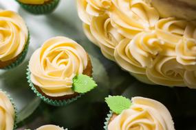 cakes with cream roses at top