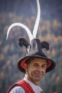 folklore artist in a hat with feathers in Texas