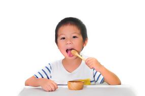boy eating honey