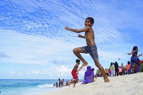 boy on the beach in the maldives