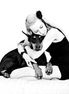 Black and white photo of the girl and cute and beautiful Doberman dog, hugging together