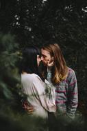 Couple kissing among the green plants