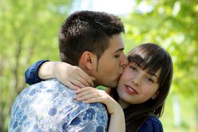 young couple in love in park on blurred background