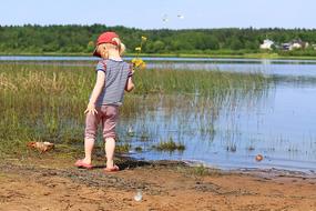 Girl Baby on Lake coast