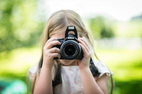 Girl Taking Picture on a blurred background