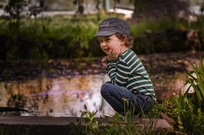 Young Happy child on lake coast