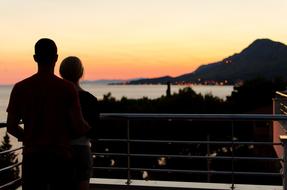 Couple in Love on balcony at sunset