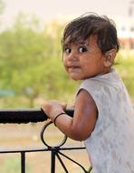 happy wet child near the parapet on blurred background