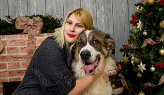 girl with dog near Christmas tree