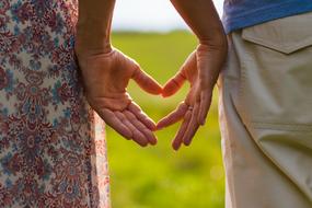 couple in Love holding hands in heart shape