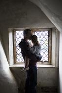 happy father with daughter in the room near the window