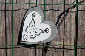heart decoration on wooden fence