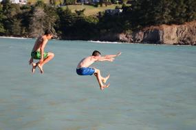 Children Boys Jumping to lake