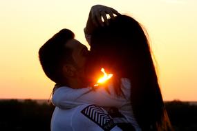 Couple kissing on the landscape, at colorful and beautiful, gradient sunset