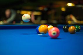 Pool Balls on a blue cloth in a blurred background