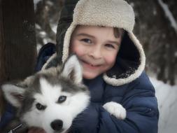 happy Child Boy with Husky dog