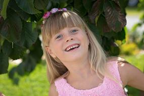 happy girl in pink dress in the garden