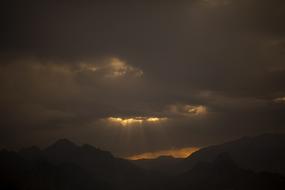 dark clouds over mountain silhouettes