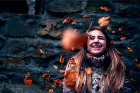 happy girl in falling autumn leaves