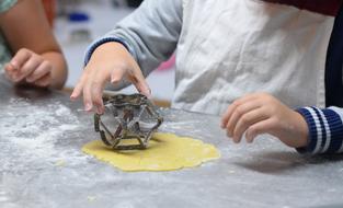 children make cookies from dough