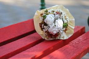 wedding bouquet on a red bench