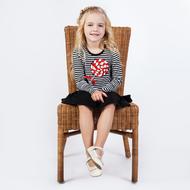 little blonde on a wicker chair