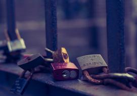 Close-up of the metal love padlocks on the metal bridge