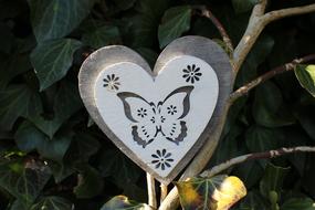 Heart with flowers and butterfly, garden decoration