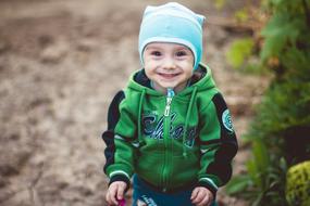 happy little boy outdoors on blurred background