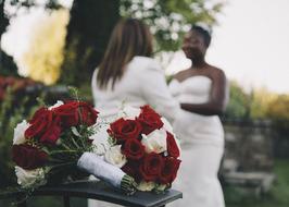 bouquet with roses on the background of a couple in love