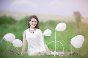 girl in dress sitting on grass