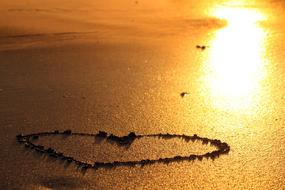 Heart shape on sandy beach
