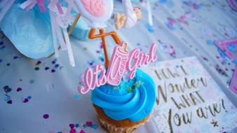 Colorful cupcake with sign, on the gender reveal party