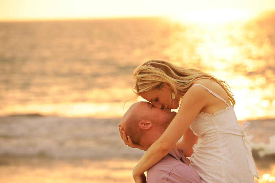 couple kissing on the beach at sunset