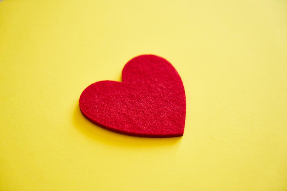 Beautiful, soft, red heart, at yellow background, in light