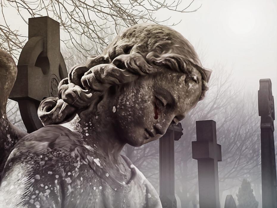 statue of an angel with bloody tears in the cemetery
