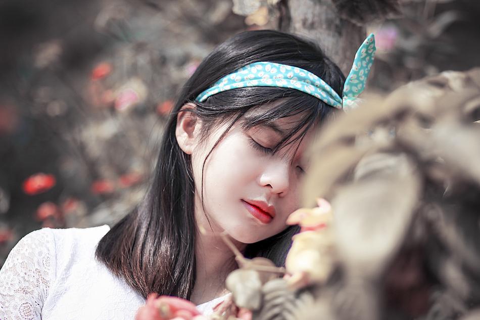 Posing girl with headband and in dress posing in Vietnam