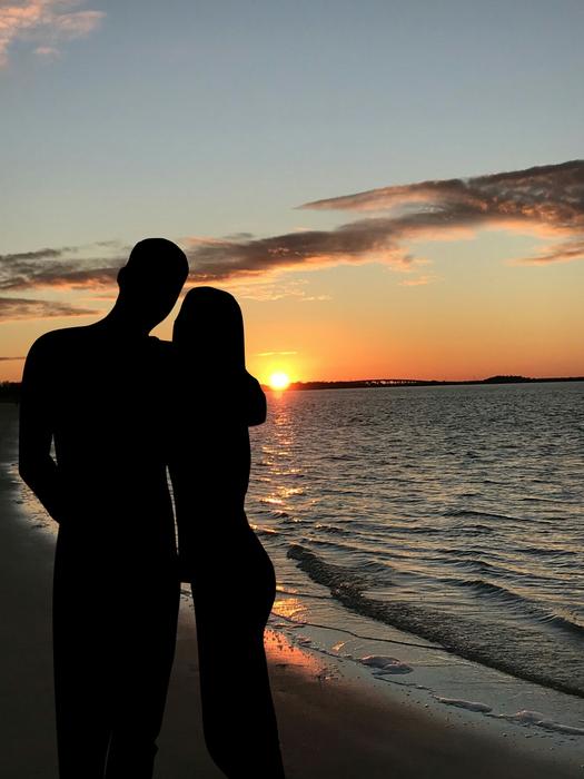 Couple on shoreline at Sunset Dusk