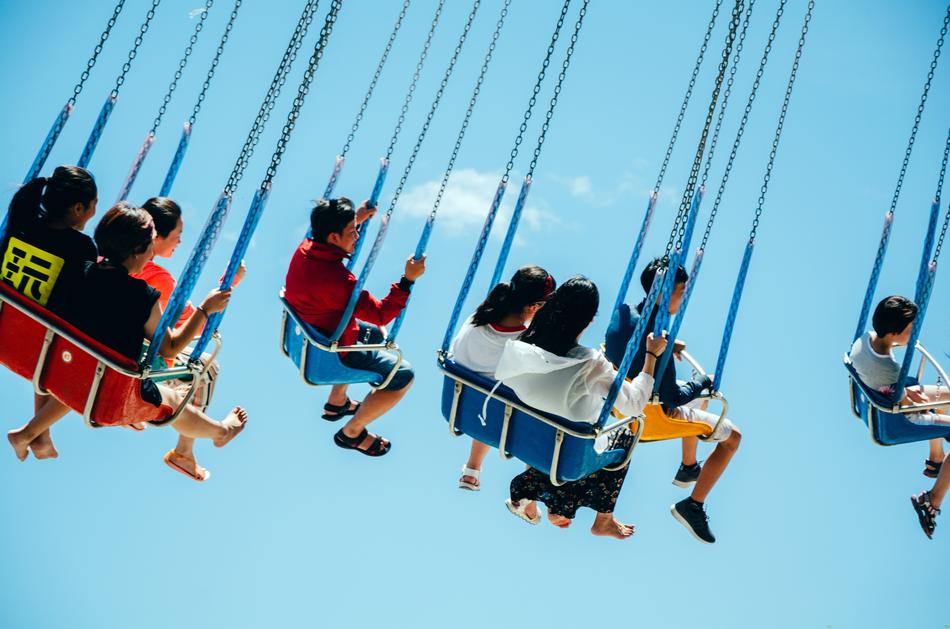 People on the attraction at blue sky with white clouds on background