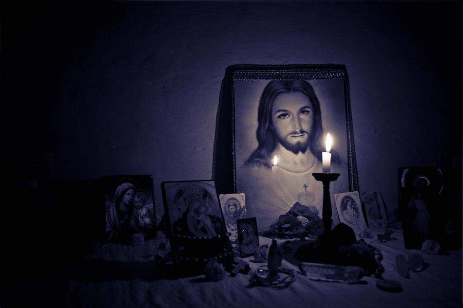 candle burning in front of home Altar