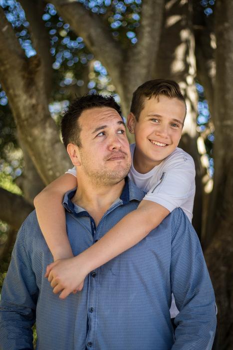 Portrait of the father and son, near the trees