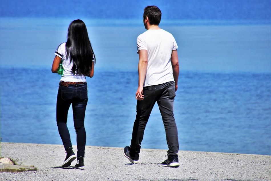 couple of young people by the lake on a sunny day