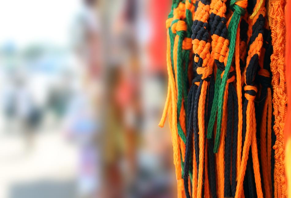 colorful threads for sale in the market in a blurred background