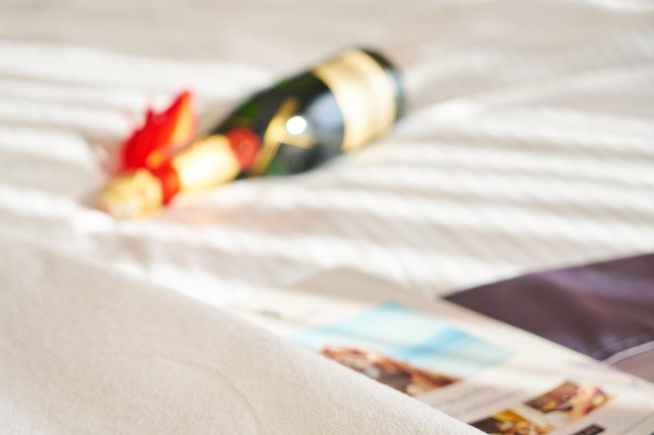 a bottle of champagne - a honeymoon gift on the hotel bed