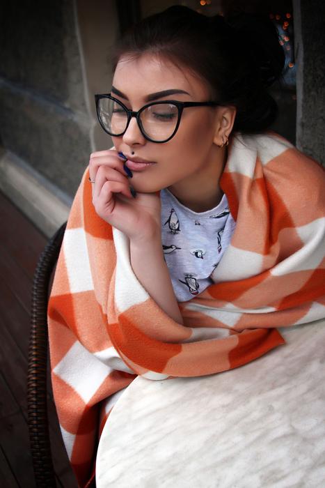 girl with glasses wrapped in a plaid