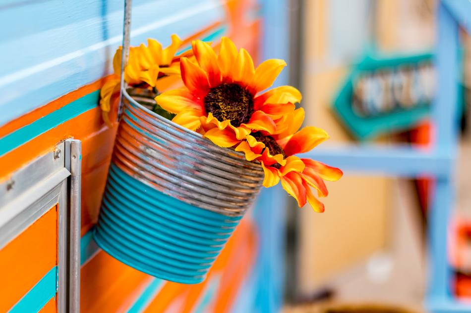 Beautiful, red, orange and yellow, gradient flowers with brown core, in the metal basket