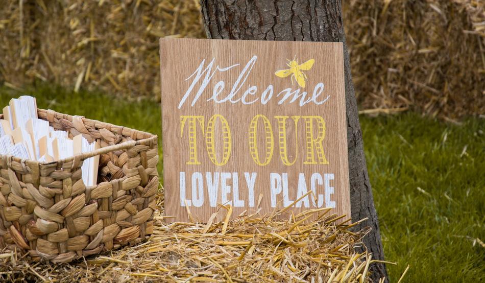 wicker basket on straw near the welcome sign