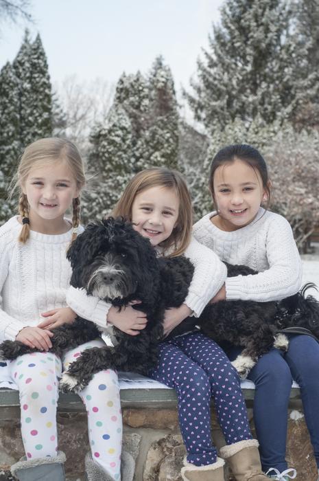 sisters with a dog at a photo shoot